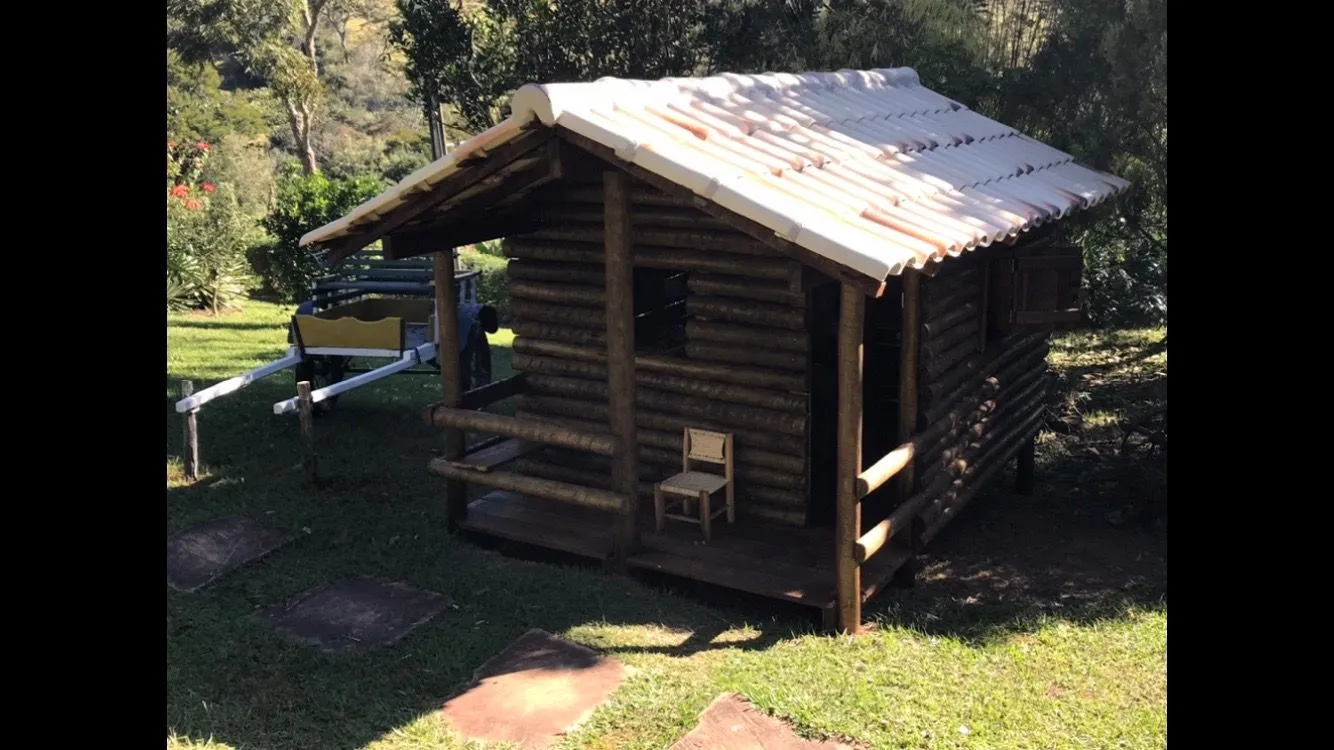 Sauna de madeira dos Chalés de Minas, com bancos escalonados e aquecedor de pedras